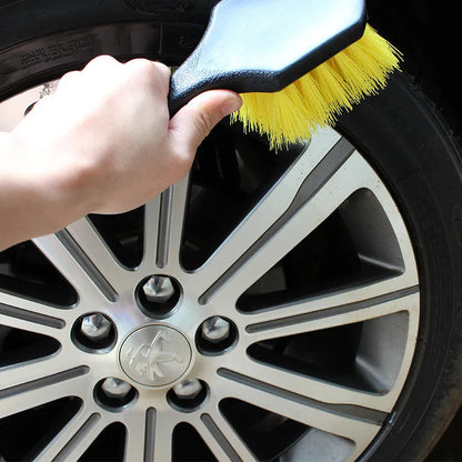 Car tire wheel brush with long handle and twisted yarn bristles for wheel hub cleaning.