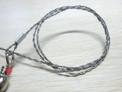 Outdoor survival wire saw with stainless steel blade and pull ring handles for camping and bushcraft