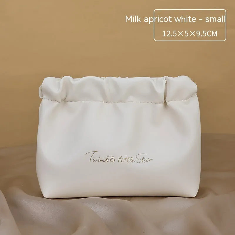 Leather travel toiletry bag with dry-wet separation compartments in caramel mocha colour with letter detailing