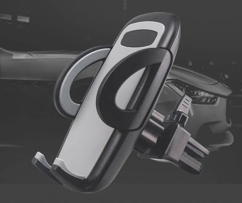 Black plastic mobile phone holder attached to a car air conditioning vent.