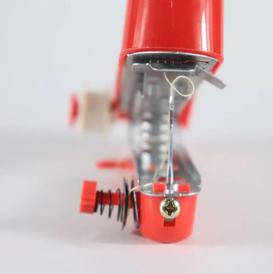 Small blue hand-held manual sewing machine showing stainless steel components and compact 11cm design