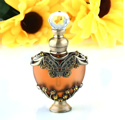 Heart-shaped refillable perfume bottle with metal and crystal construction, 3.6 inches tall