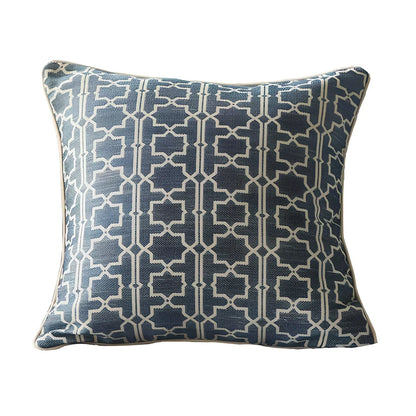 Square beige cushion cover with envelope closure on a grey sofa