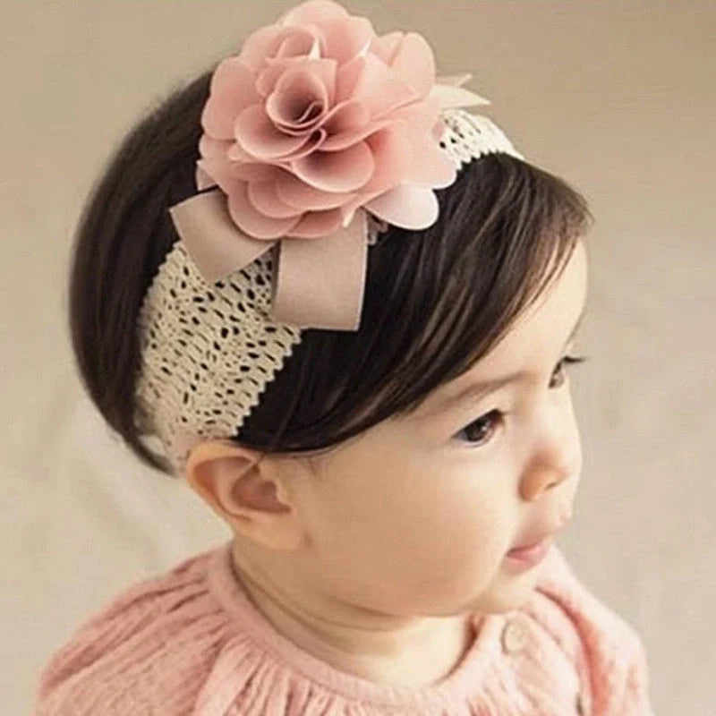 A charming flower headband for babies, featuring a delicate floral design and adjustable fit for a comfortable, stylish accessory.