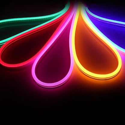 Close-up of flexible blue silicone LED neon strip showing dense LED beads, coiled on a 100-metre reel.