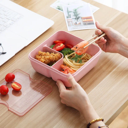 Japanese-style microwave-separated bento box in pink, green, and beige with spoon and chopsticks