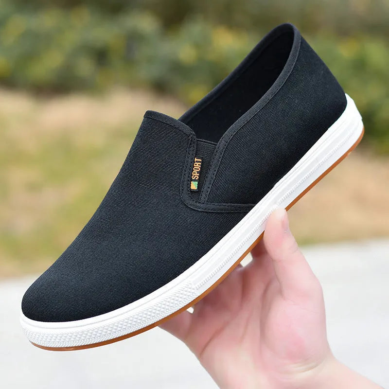 Men's low-top slip-on canvas casual shoes in black with a round toe and composite sole.