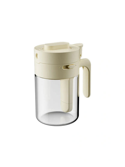 Small glass seasoning jars with lids and spoons in various colors for kitchen organization