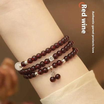 Handmade antique Chinese style bracelet with red imitation garnet and pomegranate design in a gift box.