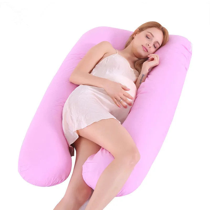 Large U-shaped pregnancy support pillow with removable cover and abdominal support belt.