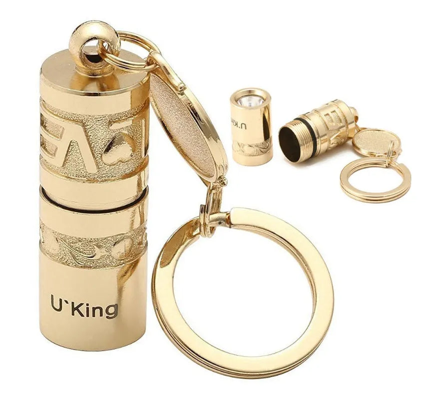 Gold electroplated waterproof mini LED keychain torch with zinc alloy body on a keyring.