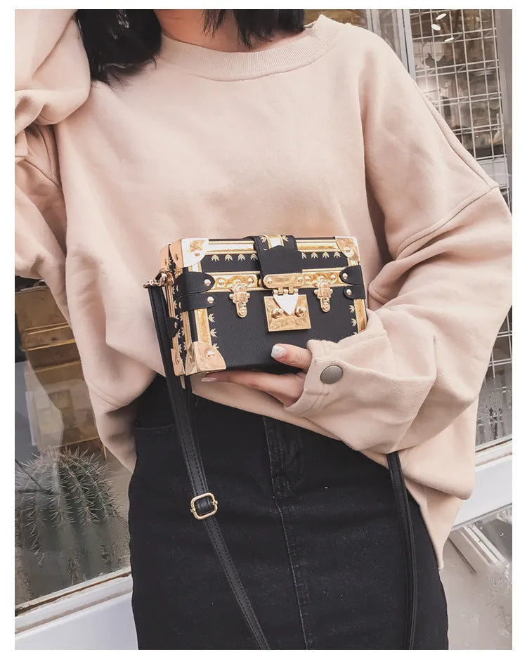 Women's hard flap shoulder bag in black or green with single adjustable strap and rivet decoration
