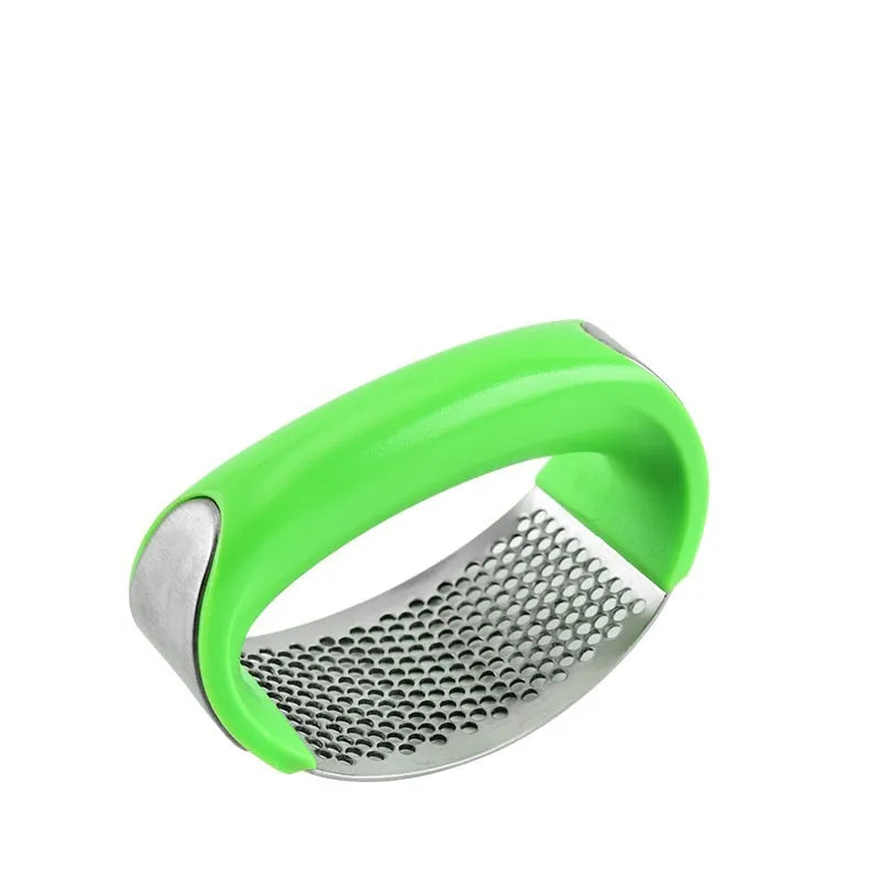 Stainless steel garlic press with ergonomic handle in kitchen setting
