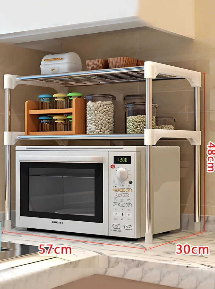 Silver and white microwave shelf rack with iron tubes and plastic connectors measuring 56.9cm wide