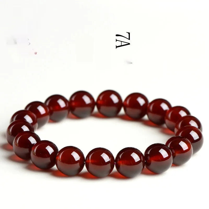 Natural orange red garnet crystal ball bracelet with traditional Ruyi design elements and adjustable bead sizing