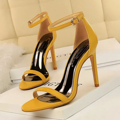 Women's open toe high heels with an ankle strap buckle in six colour options on a white background.