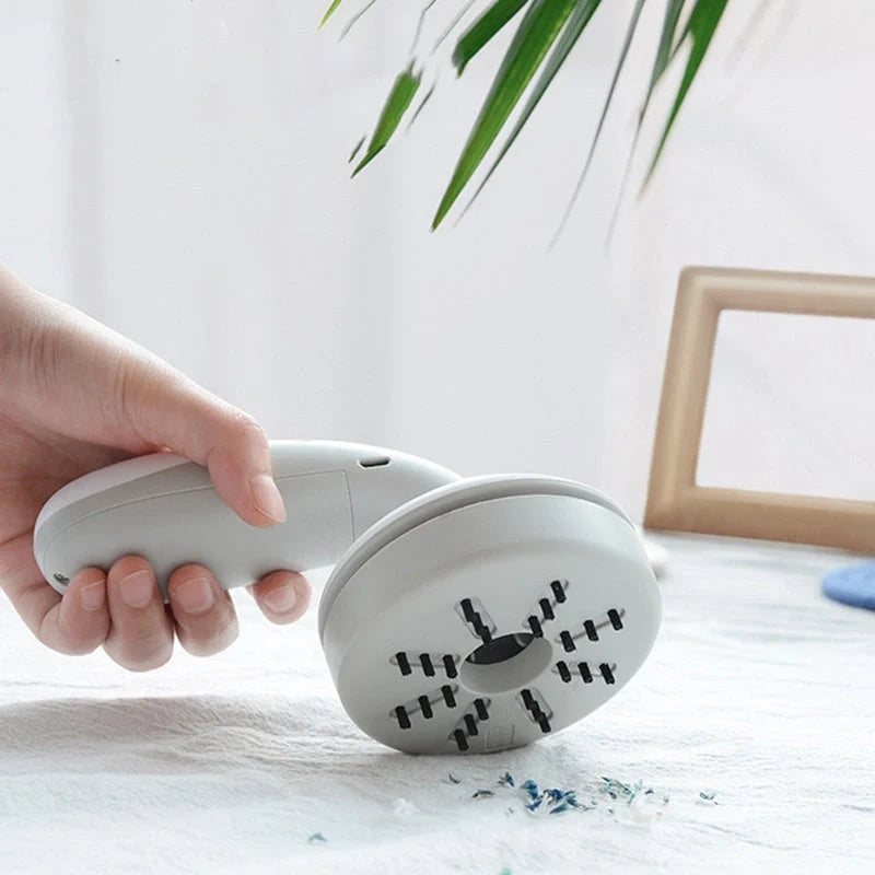 Mini desktop vacuum cleaner in pink, green, blue, and gray for dust removal