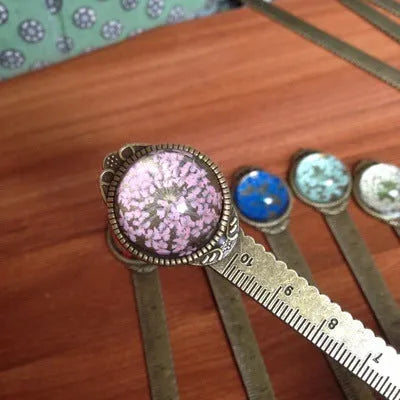 12cm handmade dried flower bookmark with gypsophila ruler featuring lace flowers, daffodils, and clover on blue background