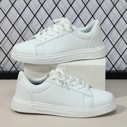Beige brown women's low-top platform casual sneakers with a cross strap and round toe on a white background.