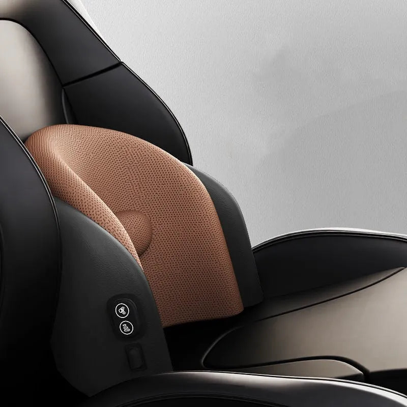 Black car massage cushion with adjustable straps attached to a car seat headrest