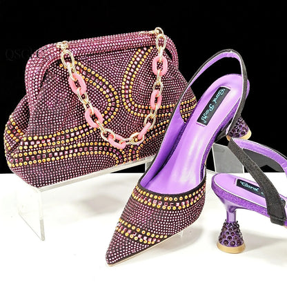 Women's pointed toe high heel court shoes in blue with rhinestone detail and a matching small bag.