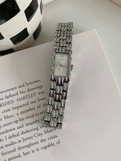 Bracelet-style women's watch with 15mm dial, 7mm thickness, mineral glass, and butterfly buckle in silver or gold.