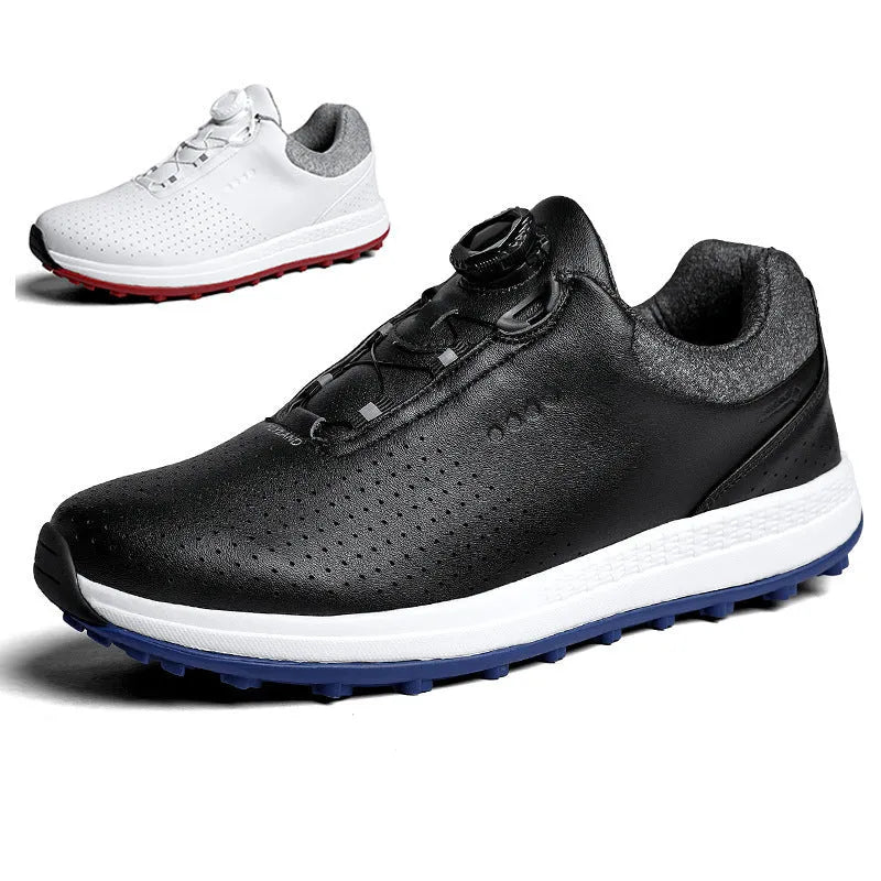 Men's white and black casual golf shoes with perforated upper and low-top design on a grass surface.