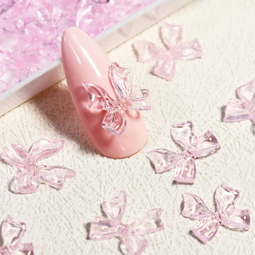 Candy pink bow-shaped 3D resin nail charms for adding a cute and playful touch to your manicure