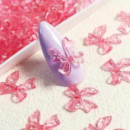Candy pink bow-shaped 3D resin nail charms for adding a cute and playful touch to your manicure