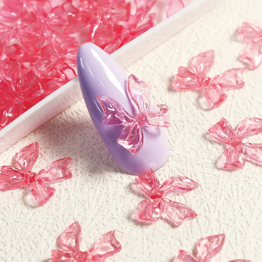 Candy pink bow-shaped 3D resin nail charms for adding a cute and playful touch to your manicure