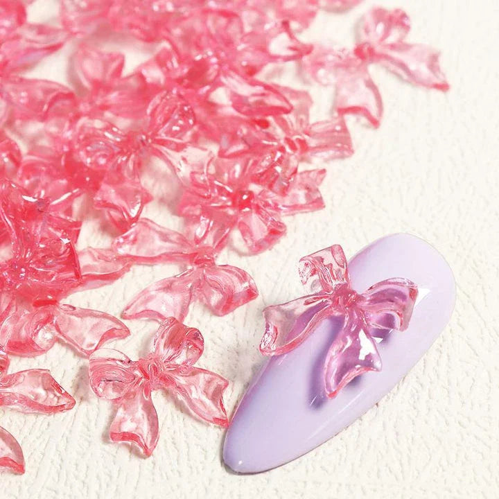 Candy pink bow-shaped 3D resin nail charms for adding a cute and playful touch to your manicure