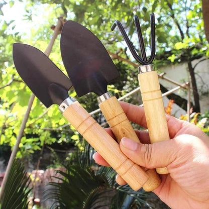 A set of 3 mini garden tools including a shovel, trowel, and rake made of premium solid wood and rust-proof iron for durable and efficient gardening