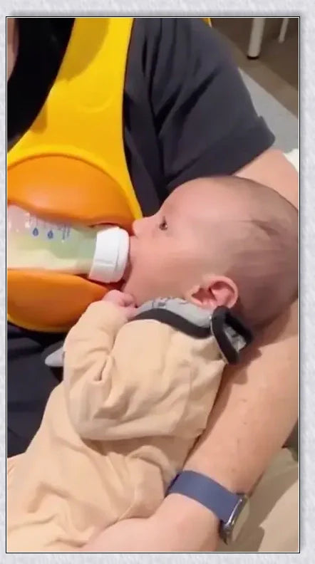 A yellow hands-free baby bottle holder that allows parents to multitask during feeding time