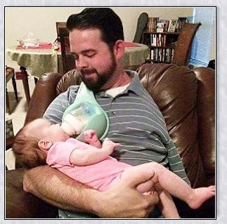 A yellow hands-free baby bottle holder that allows parents to multitask during feeding time