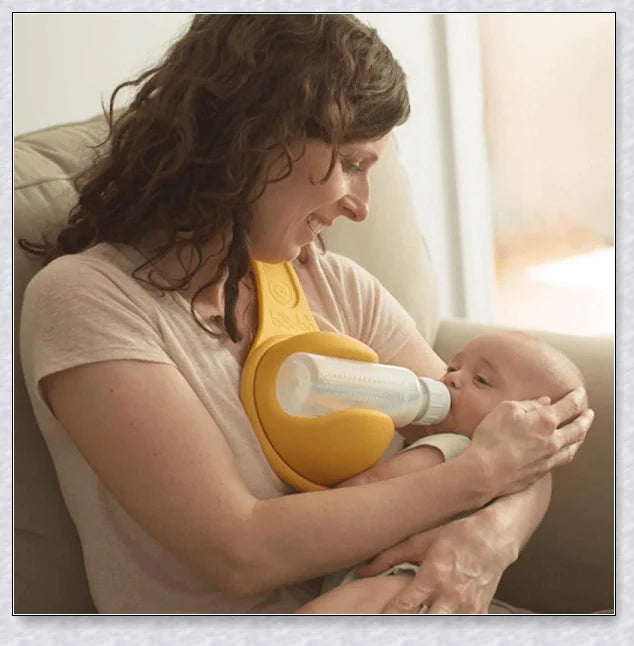 A yellow hands-free baby bottle holder that allows parents to multitask during feeding time