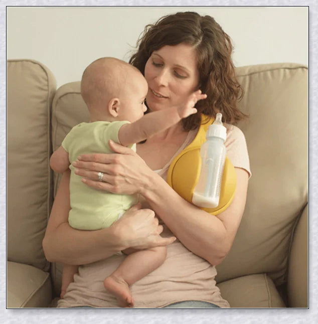 A yellow hands-free baby bottle holder that allows parents to multitask during feeding time