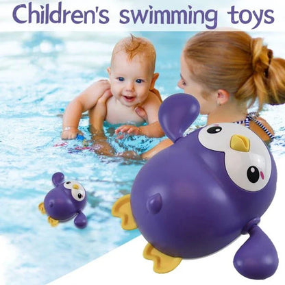 Colorful wind-up penguin bath toy swimming in the water, providing engaging water play for toddlers and young children.