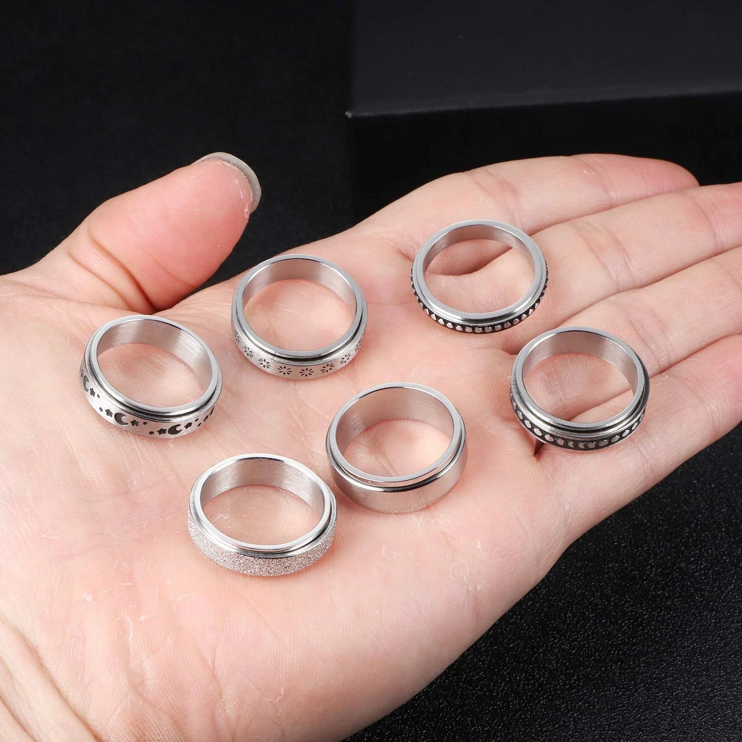 Stainless steel spinner ring with intricate moon and stars design