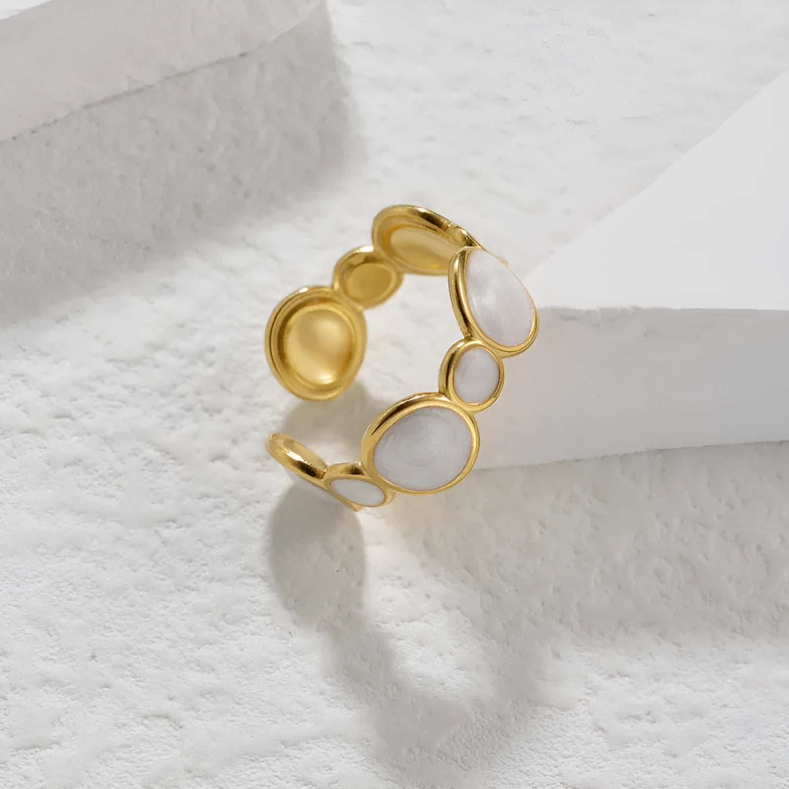 Adjustable geometric stainless steel ring with electroplated finish showing angular design and opening mechanism