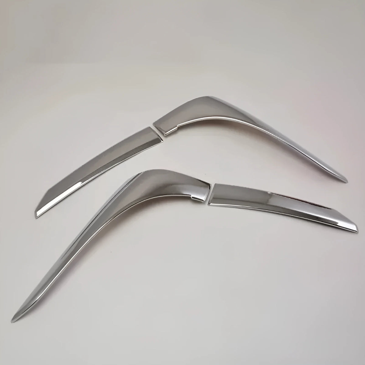 Set of four silver electroplated tail light eyebrow trims for Mitsubishi Outlander on white background.