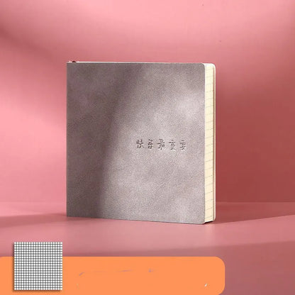 Square faux leather mesh cover notebook open on a blank Daolin paper page.