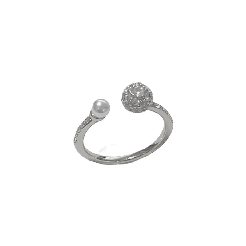 Open-end pearl ring with round zircon stones on geometric copper band with gold plating