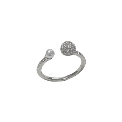 Open-end pearl ring with round zircon stones on geometric copper band with gold plating