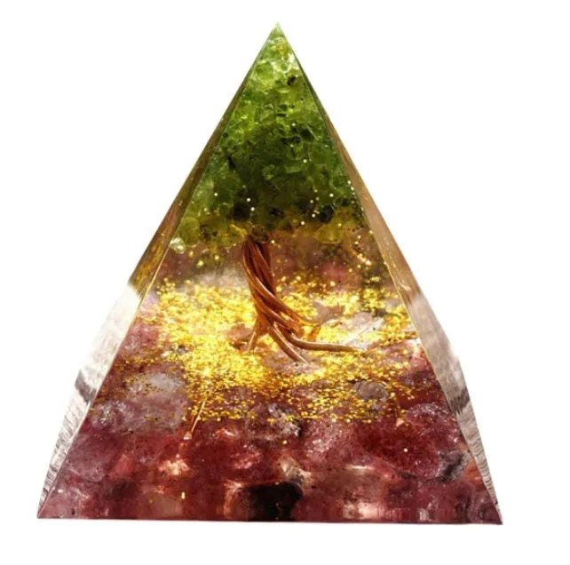 A small 6cm clear epoxy resin pyramid ornament containing pieces of natural crystal gravel on a flat surface.
