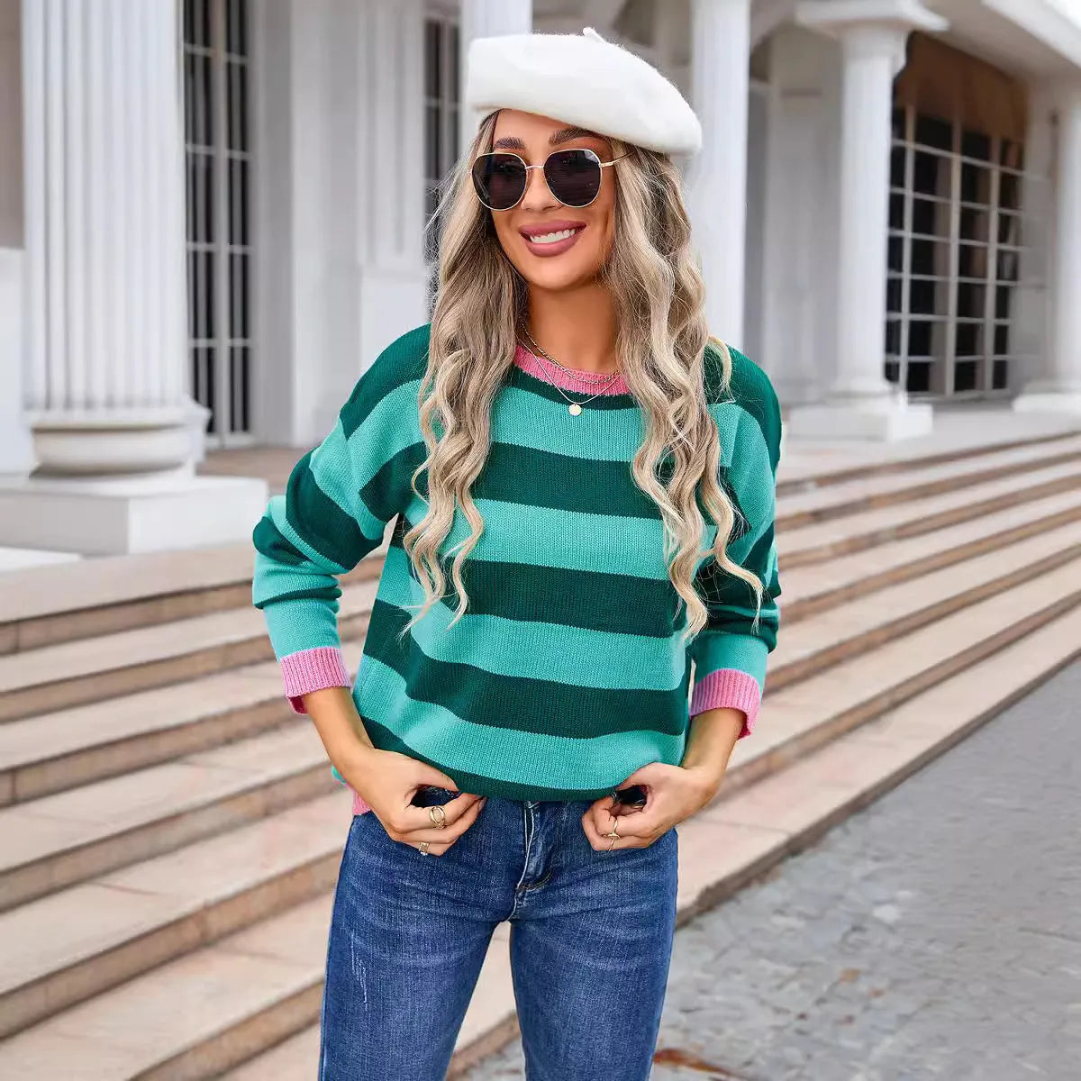 Women's loose fit striped long sleeve round neck sweater on a hanger.