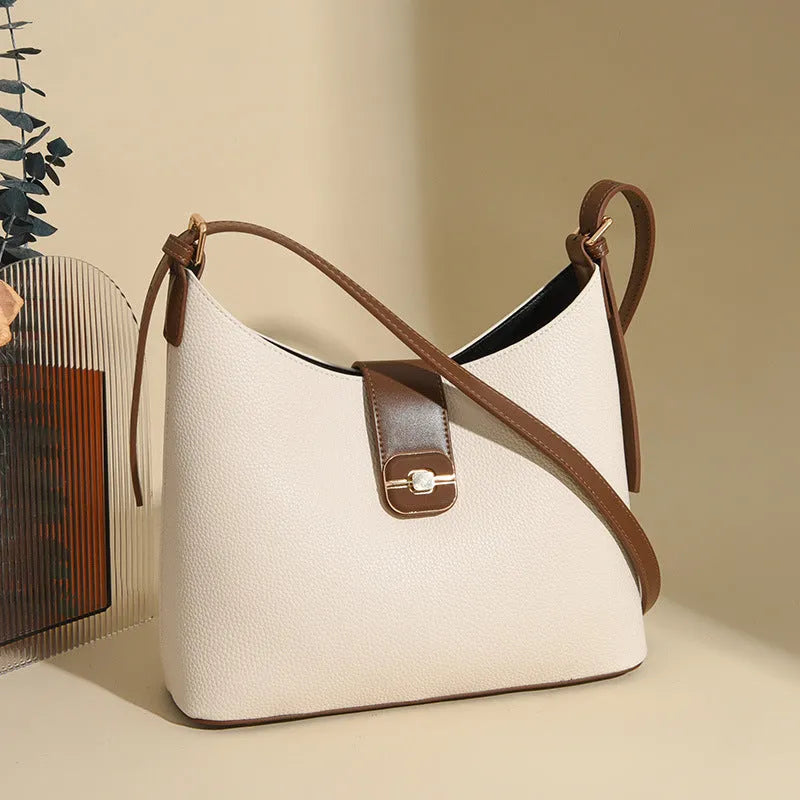 PU bucket shoulder bag in biscuit colour showing internal phone compartment and zippered sections
