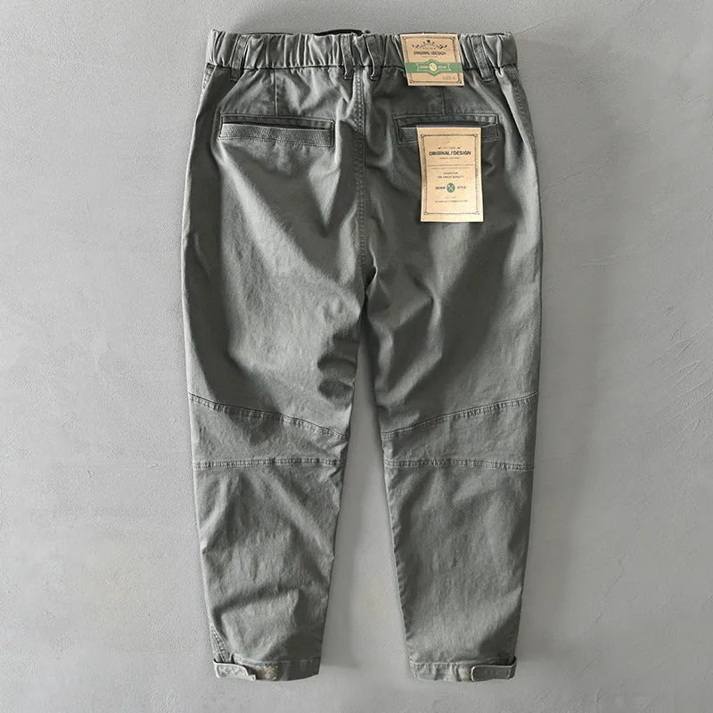 Man wearing khaki-coloured loose-fit cotton casual overalls with an elastic waist.