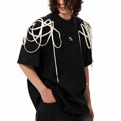 Black loose fit short sleeve t-shirt with padded shoulder detail on a hanger.
