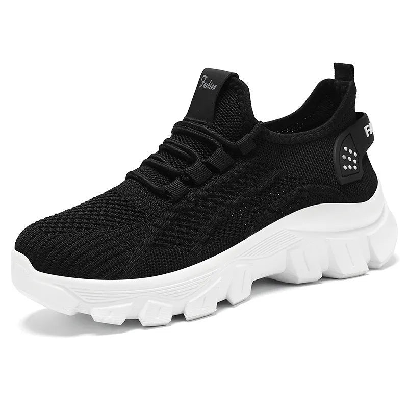 Women's white Flyknit sneakers with a thick PVC sole and lace-up front.