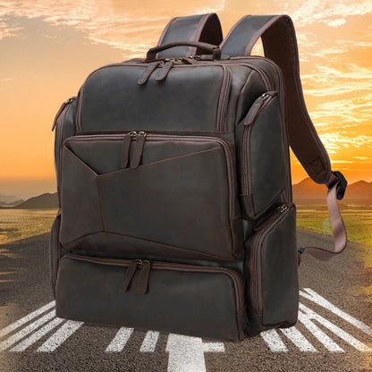 Dark brown leather backpack with embossed texture, double shoulder straps, and multiple zippered compartments for 17-inch laptops